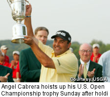Angel Cabrera hoists up his U.S. Open Championship trophy Sunday after holding off Tiger Woods to win the title at 5-over-par.