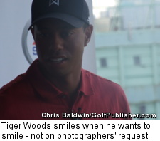 Tiger Woods smiles when he wants to smile - not on photographers' request.
