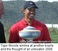 Tiger Woods smiles at another trophy and the thought of an unbeaten 2008.